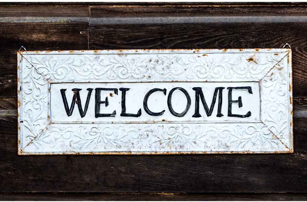 A weathered sign that says Welcome